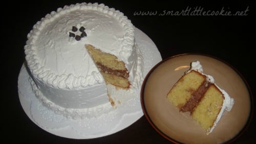 A Dominican cake with a slice taken out of it and served on a plate.
