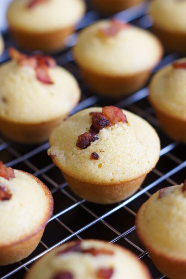 Bacon corn muffins on a cooling rack.