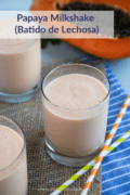 Papaya Milkshake (batido de lechosa) served in three glasses with straws on the side.
