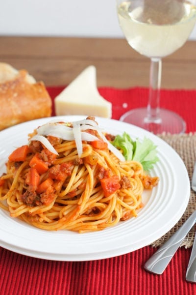 Spaghetti and meat sauce served on a white plate.