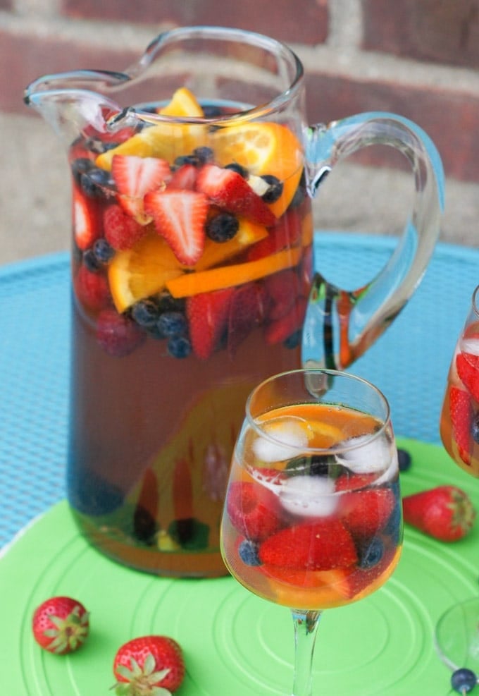 Sangria in a tall pitcher and poured into two glasses.