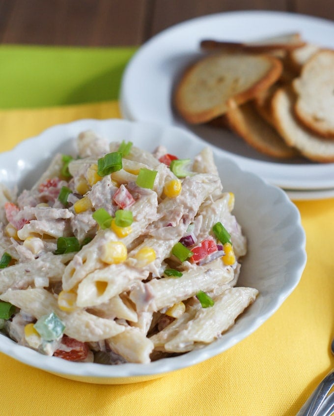 Tuna penne pasta salad served in a white bowl.