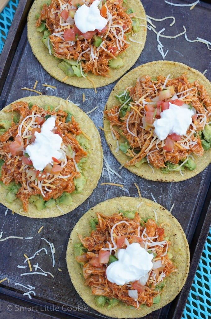 Overhead shot of four tostadas with chipotle chicken topping.