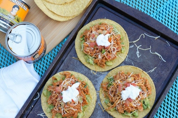 Three chicken tostadas on a baking sheet.