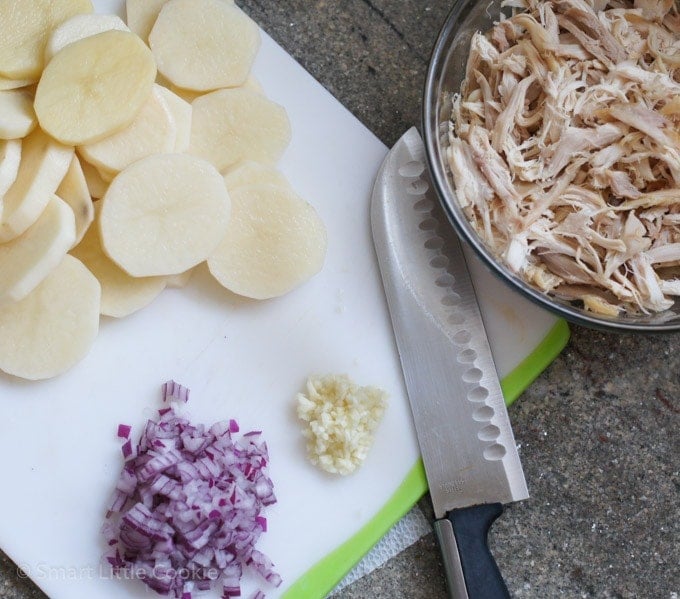 Ingredients being chopped on a cutting board.