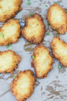 Yuca fritters on a foil lined tray.
