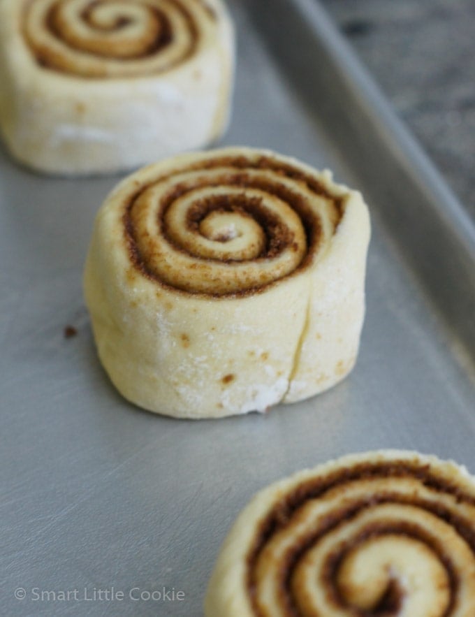 Close up of an unbaked cinnamon roll on a baking sheet.
