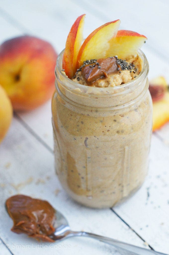 Overnight oats in a jar topped with sliced of apple.