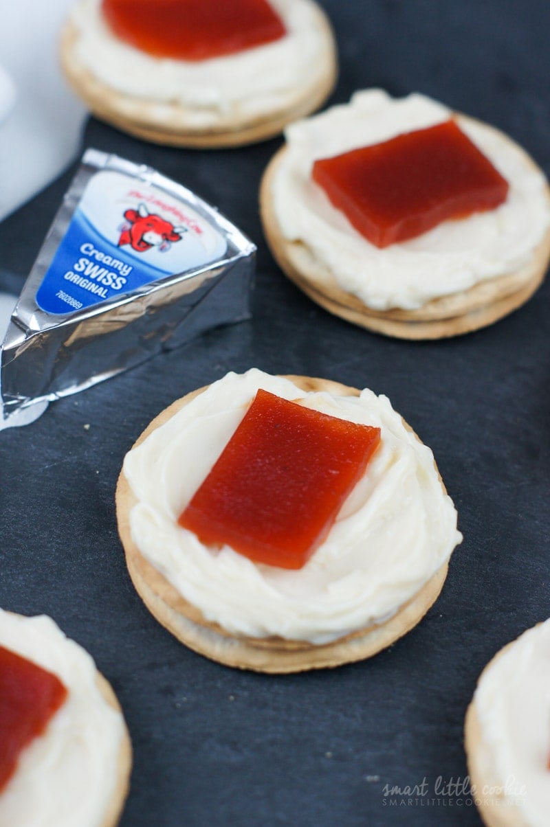 Two cream cheese and guava bites next to a triangle of cream cheese.