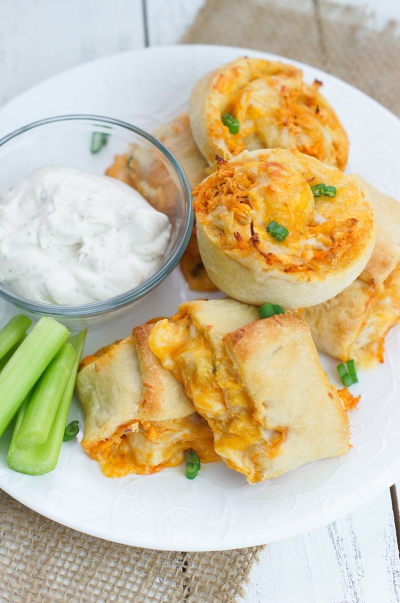 Buffalo chicken rolls served with a dip and celery sticks.