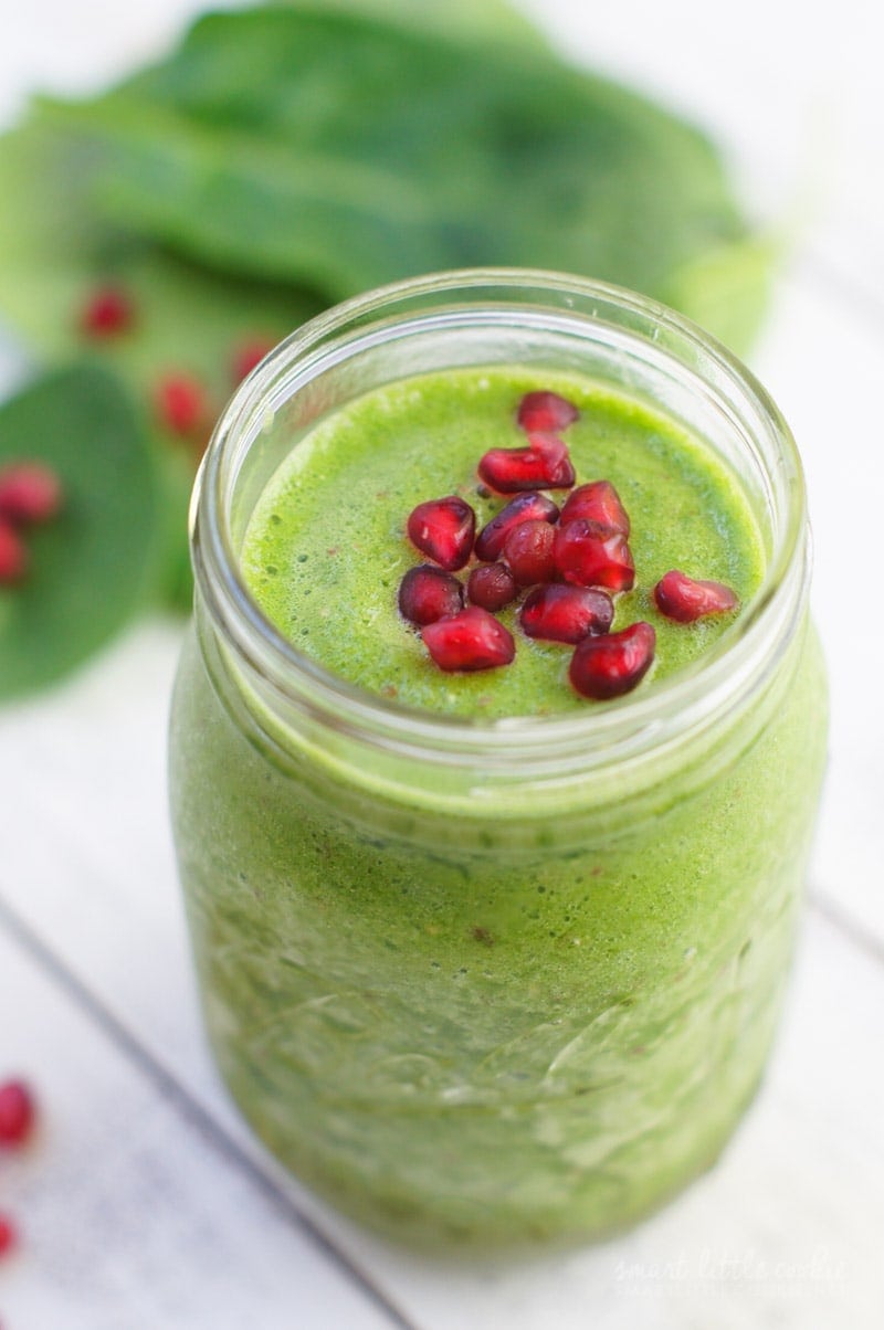 Close up of the pomegranate seeds on top of the green coconut smoothie.