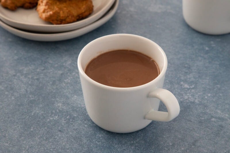 A warm cup of rich hot chocolate served in a white mug.