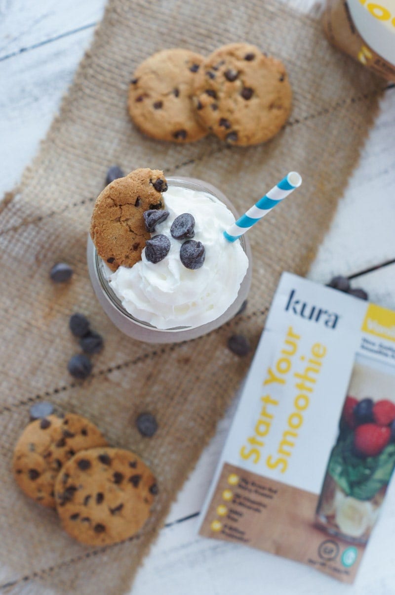 Overhead shot of the smoothie next to chocolate chip cookies and a pack of protein powder.