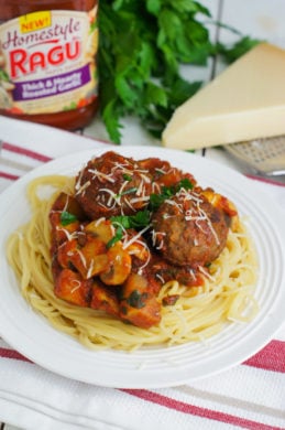 Mushroom and zucchini bolognese with meatballs served on spaghetti.