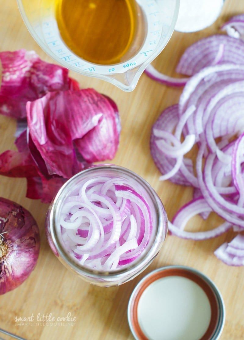 Overhead shot of sliced red onions in a jar.