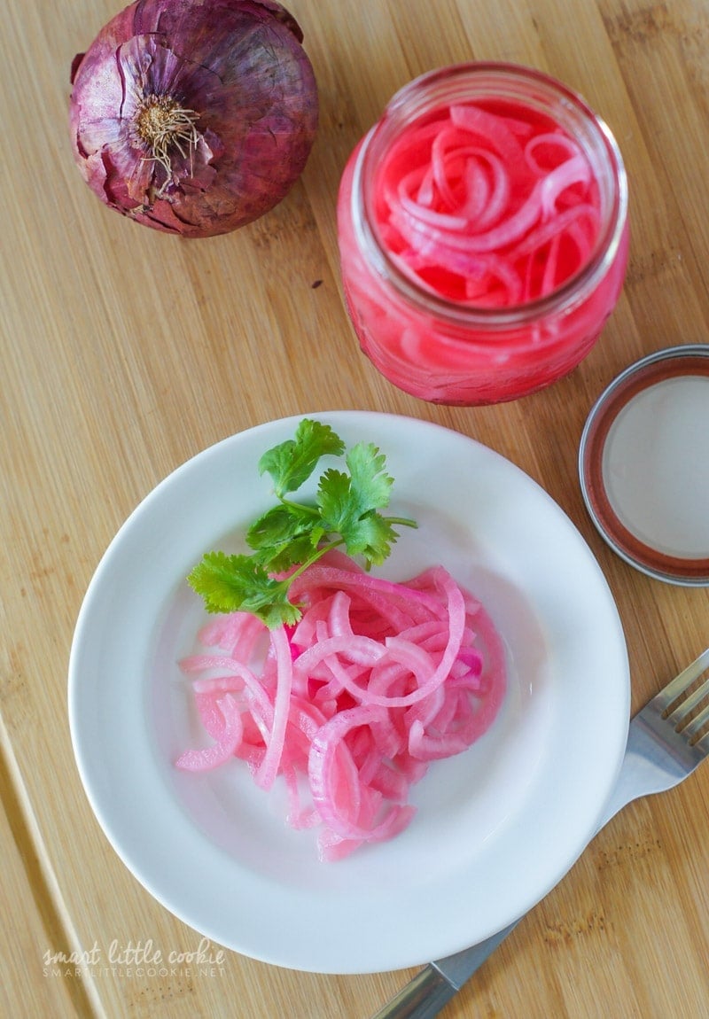 Overhead shot of pickled onions on a plate.