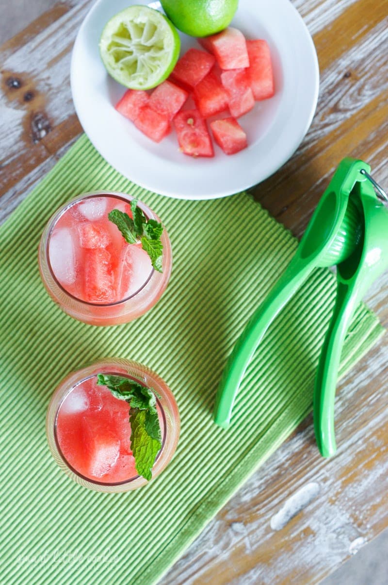 Overhead shot of two watermelon drinks garnished with mint.