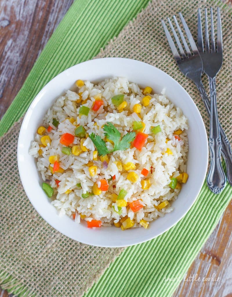 Overhead shot of rice and vegetables in a white bowl.