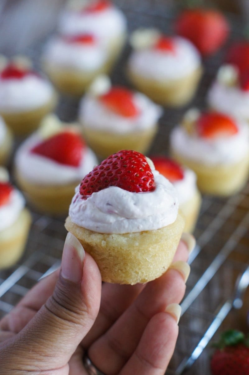 A hand holding a Strawberry Cheesecake Cookie Cup.
