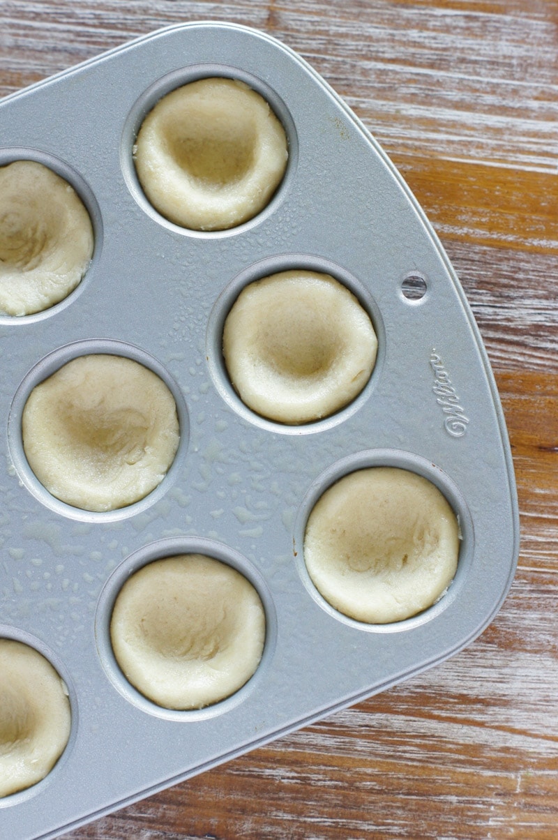The dough pressed into a muffin mold.