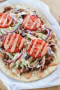 Easy Dominican Style Flatbread Chimi Pizza ~ Inspired by the popular Dominican burger, Chimi, traditionally served by street vendors in the Dominican Republic, this pizza is made with flatbread, sausage, cabbage, onions, tomatoes and a mayo-ketchup sauce. www.smartlittlecookie.net #pizza #ad #FlatoutLove