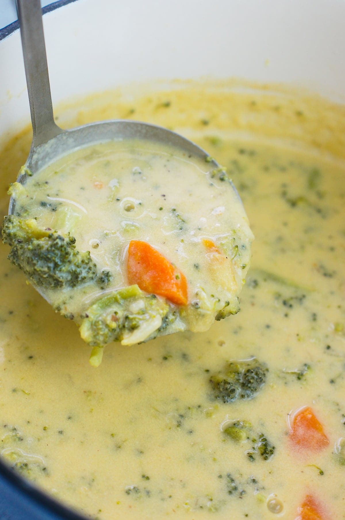 A simple cheese broccoli soup recipe that is easy to make and filled with delicious cheddar cheese, broccoli and carrots. mydominicankitchen.com #soup