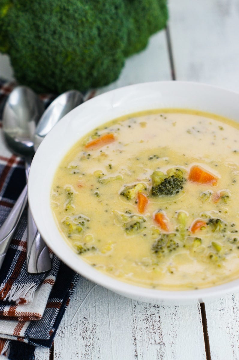 A simple cheese broccoli soup served on a white bowl