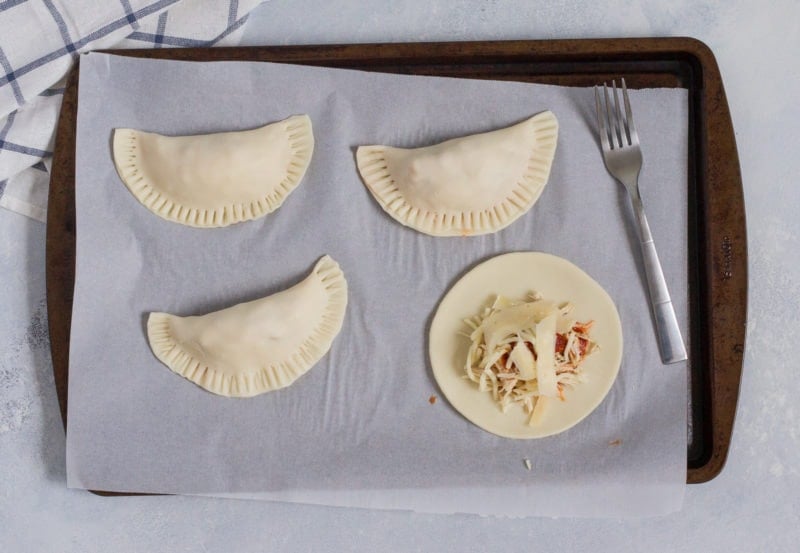 The empanadas being folded over.