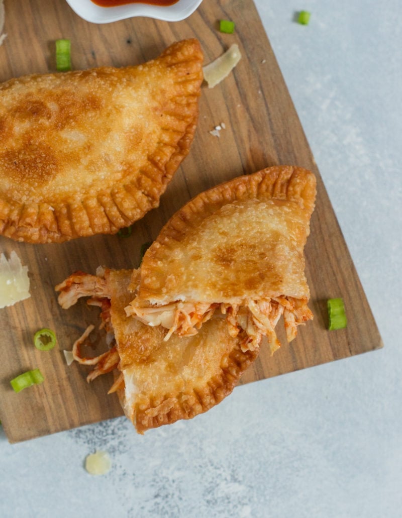 A chicken empanada broken in half.