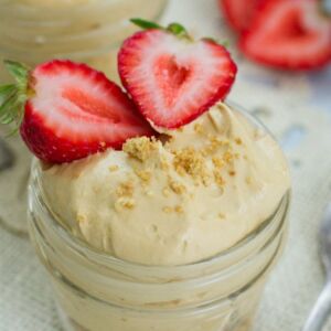 Close up of sliced strawberries on top if the cheesecake.