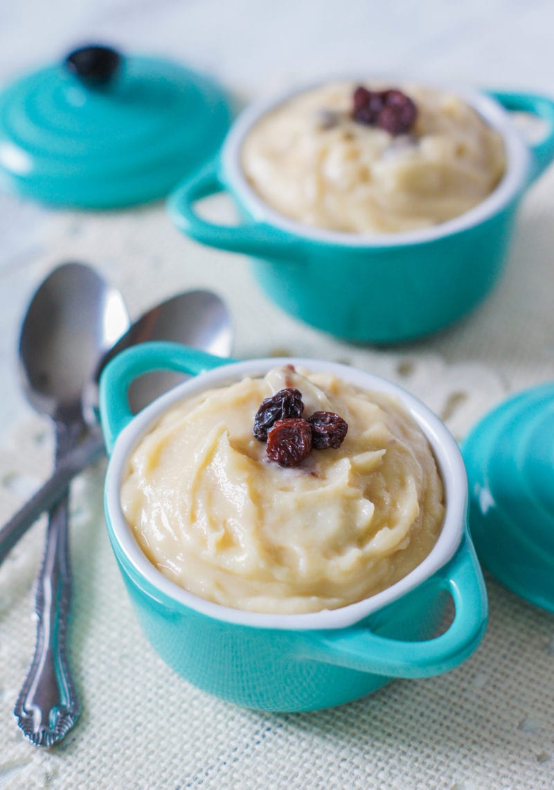 Two blue bowls with the Dominican pudding topped with raisins.