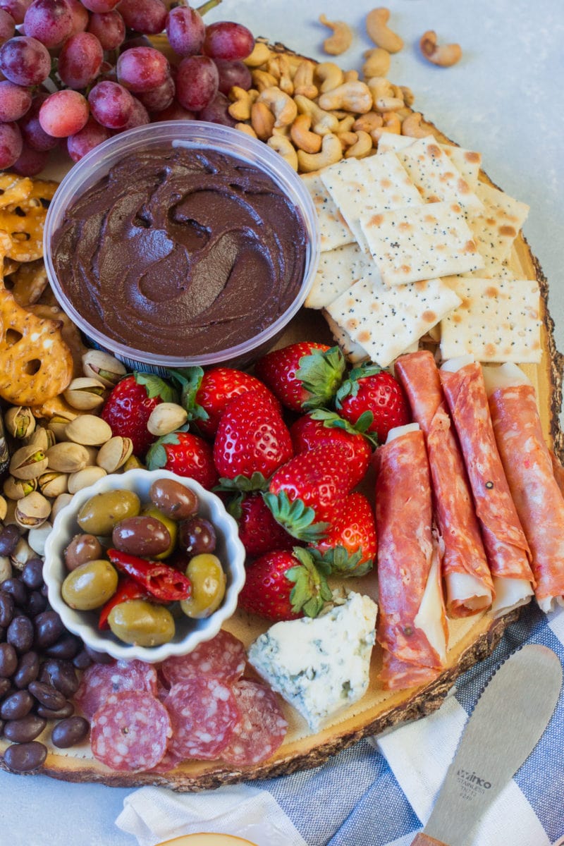 Meats and fresh berries on a platter.