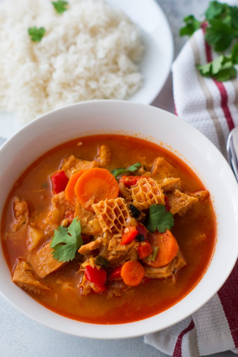 Mondongo served on a white bowl with a size of white rice. 