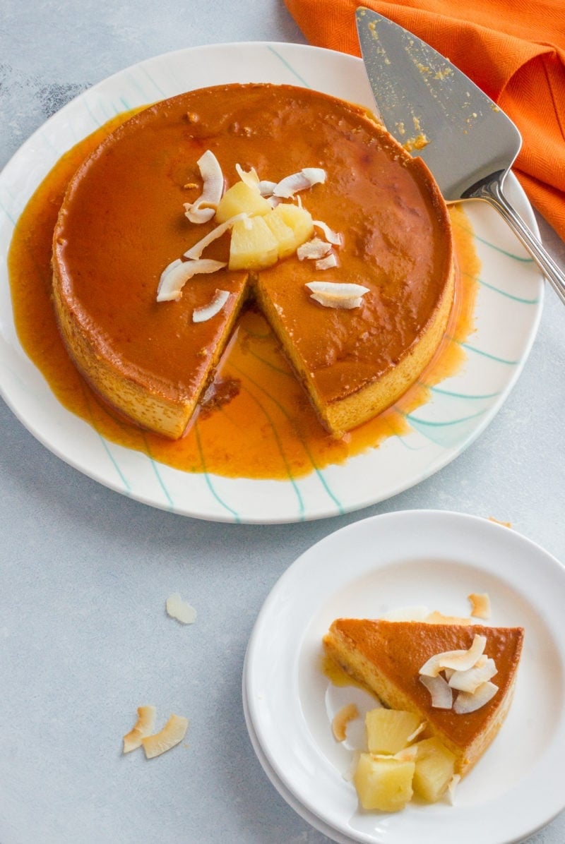 A slice of pineapple flan served on a white plate.