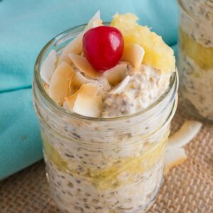 Pina colada overnight oats topped with a cherry.