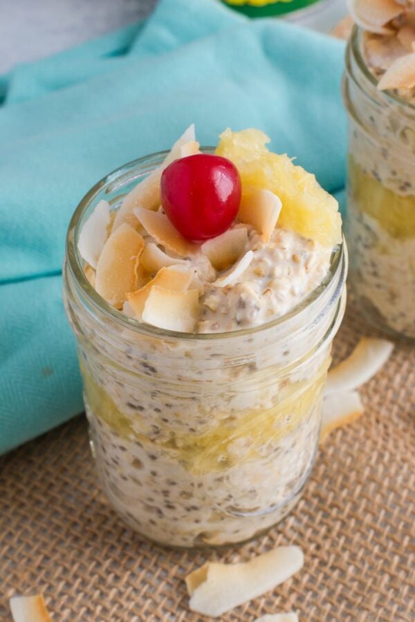 Pina colada overnight oats topped with a cherry.