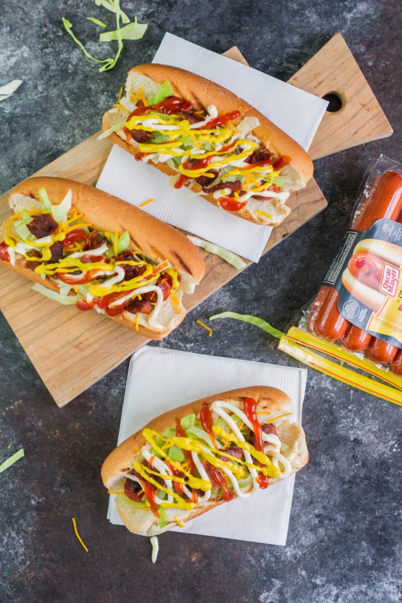 Overhead shot of three dressed Dominican hot dogs.