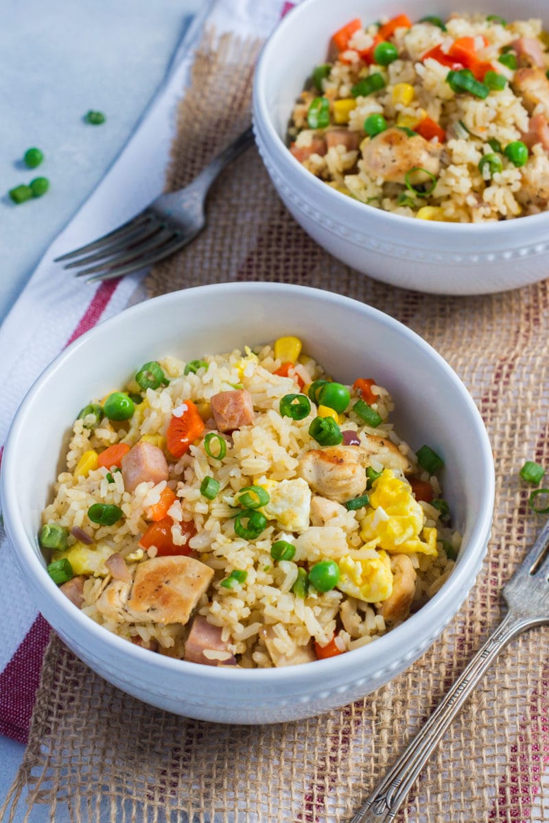 Fried rice served in a two white bowls.