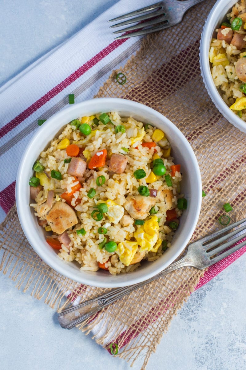 A bowl of Dominican chofan next to a fork.