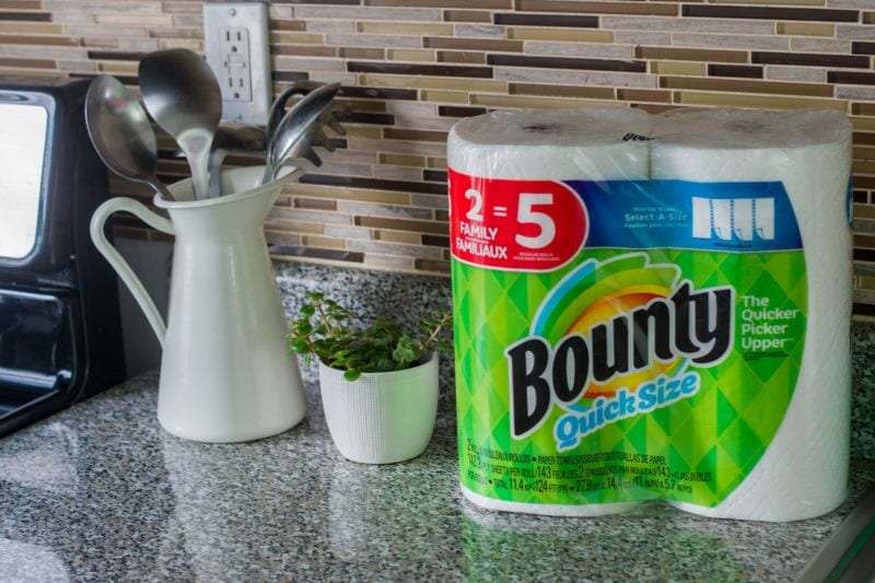 A kitchen counter with a pack of Bounty kitchen towel next to kitchen utensils.