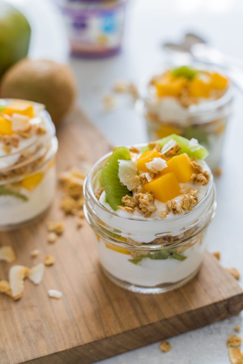 Close up of a parfait topped with fresh tropical fruits and granola.