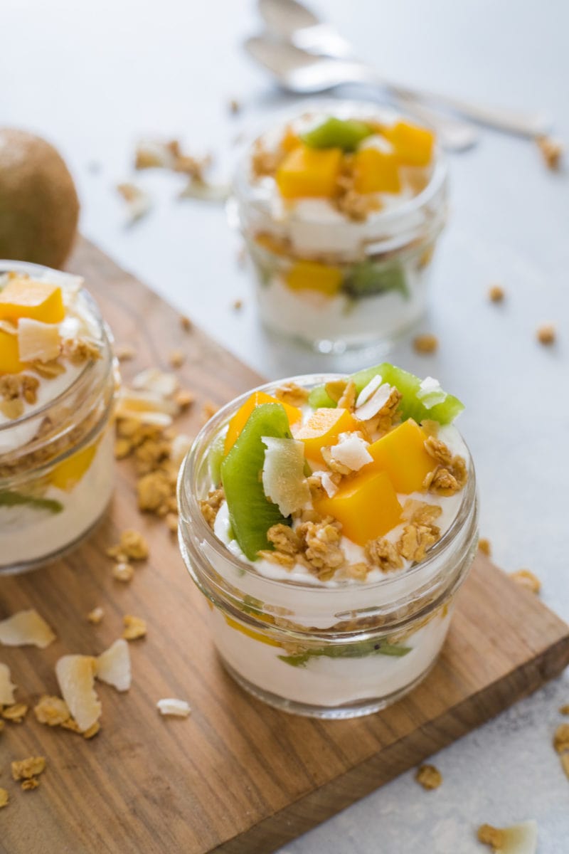 A yogurt parfait topped with fresh fruits and nuts.