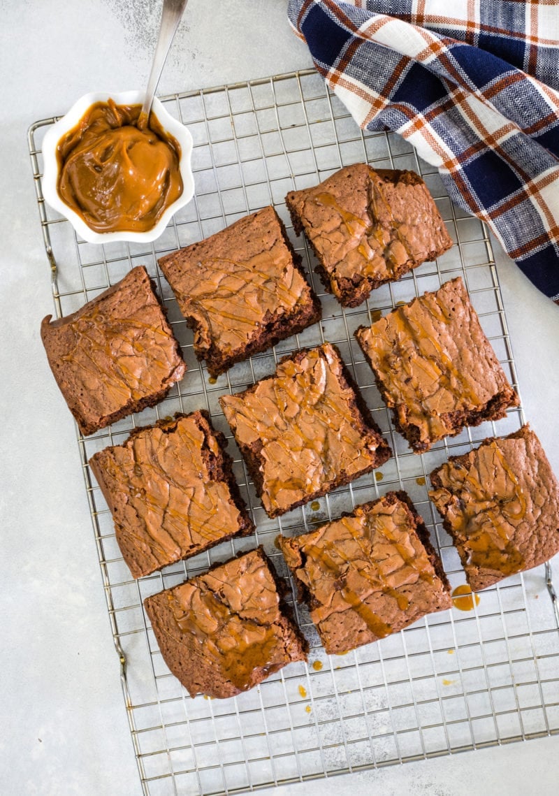 Dulce de leche brownies cut into 9 squares on a cooling rack.