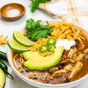 easy Instant Pot Chicken Tortilla Soup is filled with spicy flavors, shredded chicken, black beans, fire roasted tomatoes, and corn.