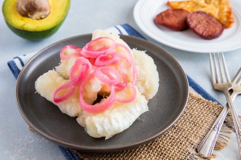 Yuca served with onions on a plate