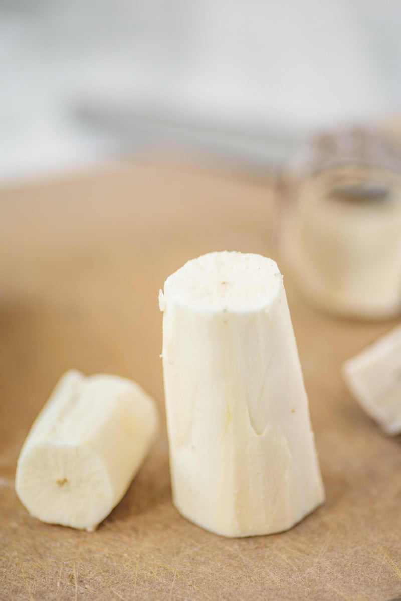 Peeled Yuca root on a cutting board