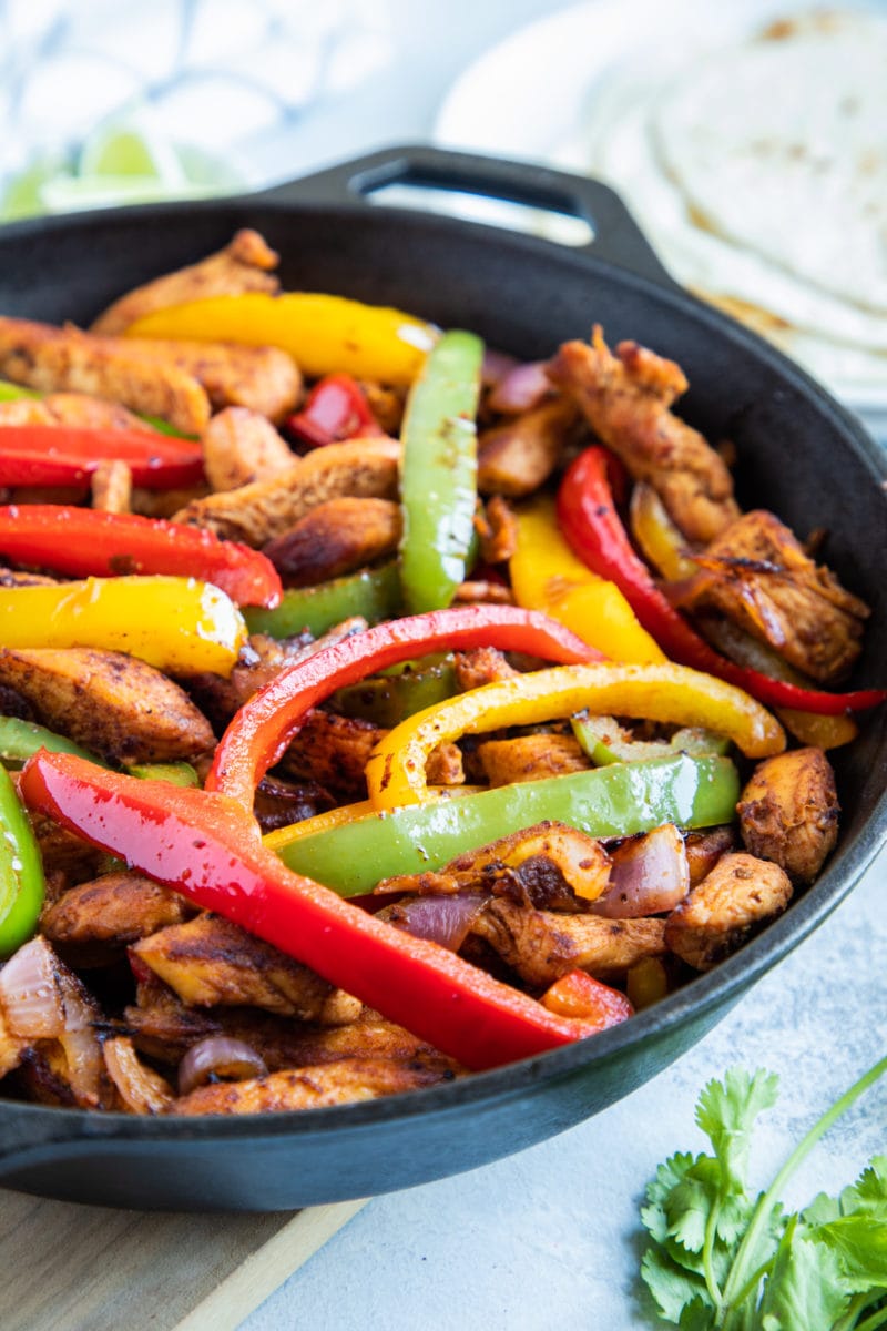 Close up of chicken fajitas in skillet. 