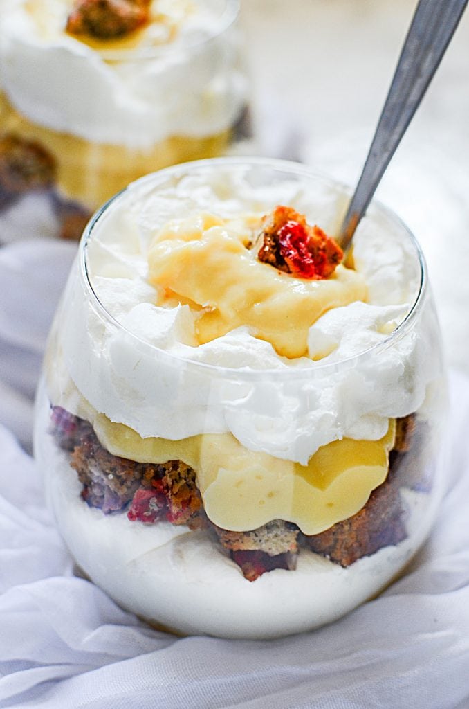 A banana bread parfait in a glass with a spoon.