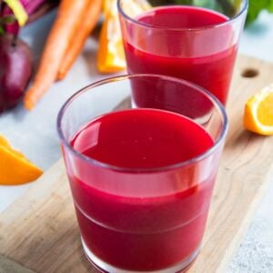 Two glasses of beet, carrot and orange juice.
