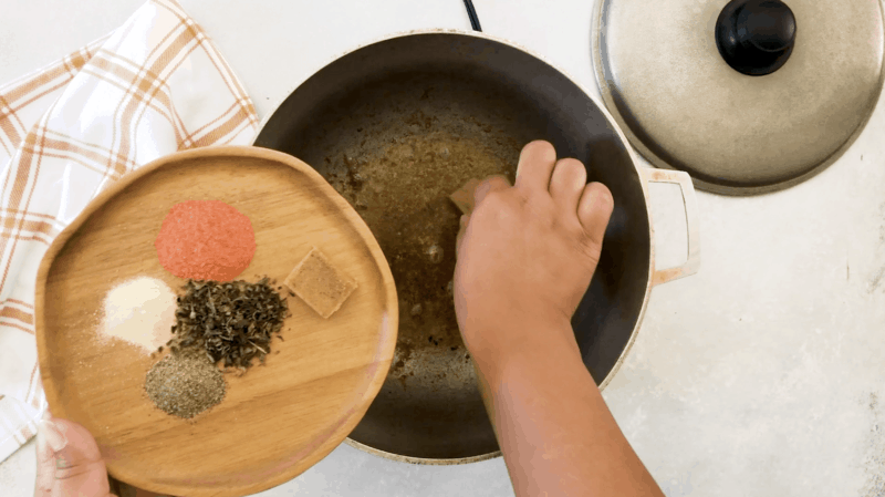 Adding the seasonings in the pan.